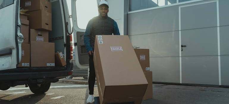 A Delivery Man pulling a Trolley with Carton Box on a moving day in Seattle